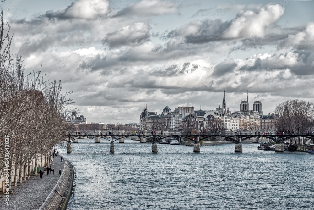 Pont des Arts and Ile de la Cite in winter under a heavy sky - Paris, France
