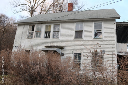 Old abandoned wooden weathered abandoned New England farmhouse 