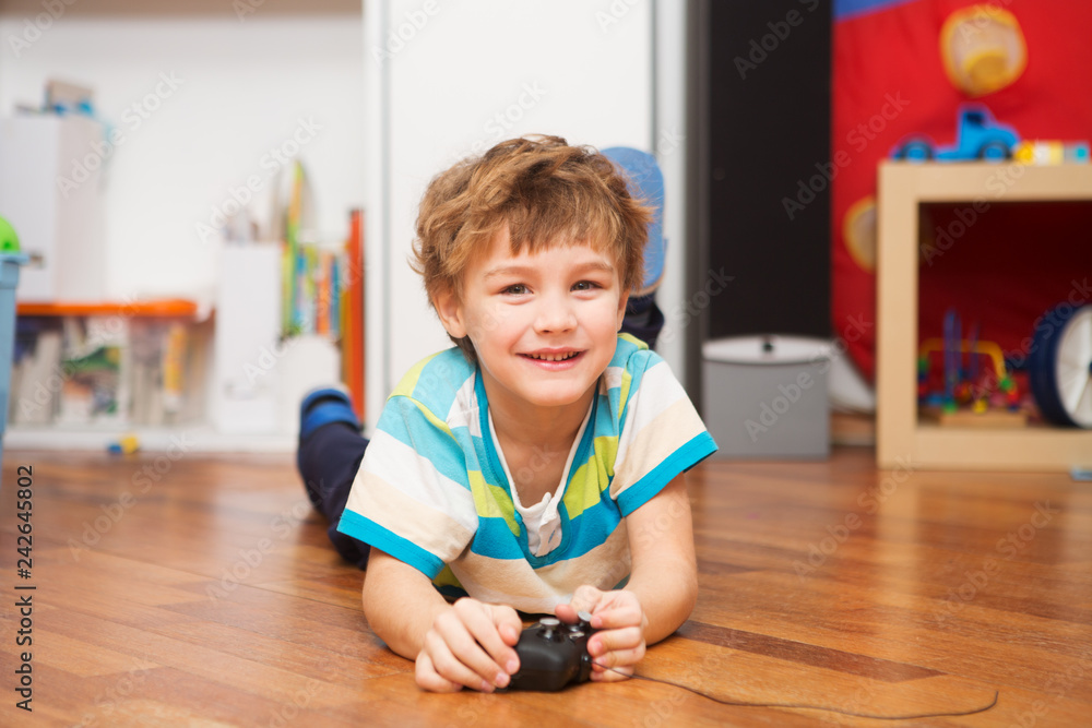 Fototapeta premium a boy playing with radio-controlled car at home.