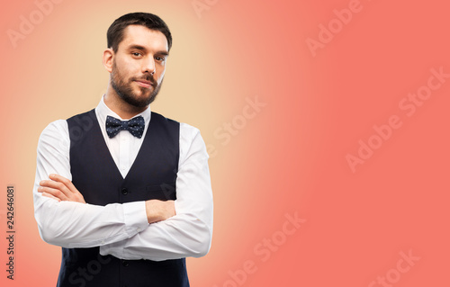 people concept - man in party clothes and bowtie over living coral background