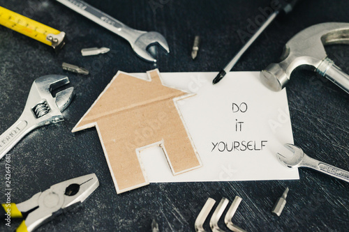 set of DIY tools with little cardboard house and copyspace to add your text