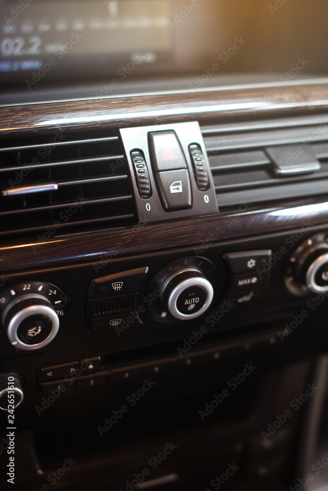 Air conditioning button inside a car. Climate control AC unit in the new car. Modern car interior details.