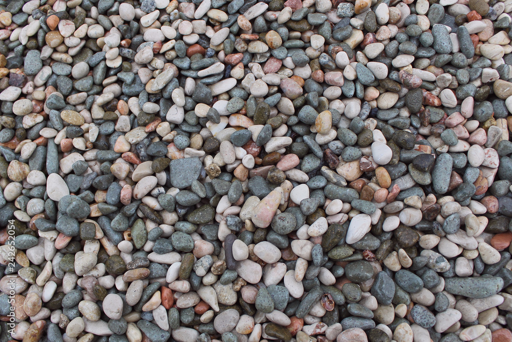 Colored texture pebbles on the beach Colored texture pebbles on the beach