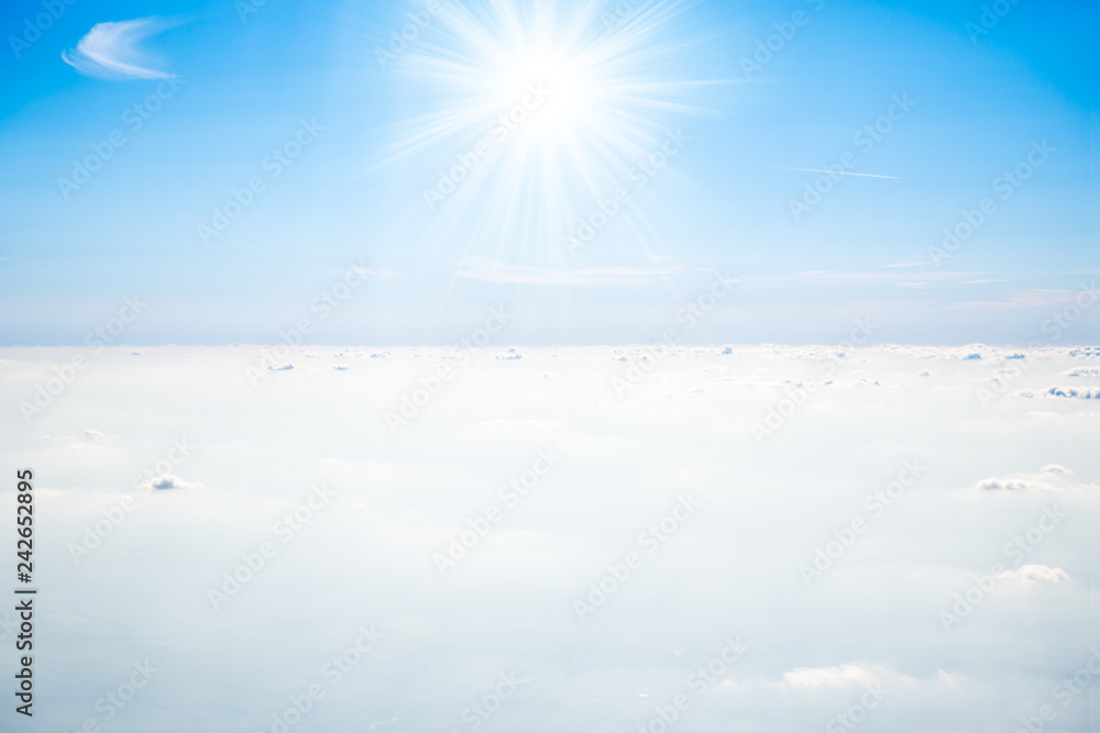 Sun on clear blue sky and beautiful white clouds