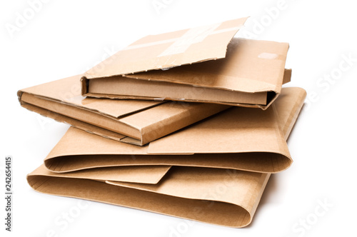 Stack of cardboard book mailers on white background.