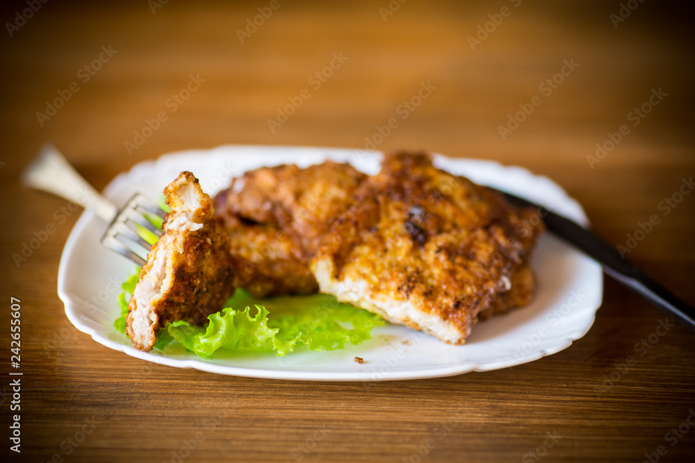 pork fillet chop fried in batter, in a plate pork fillet chop fried in batter, in a plate