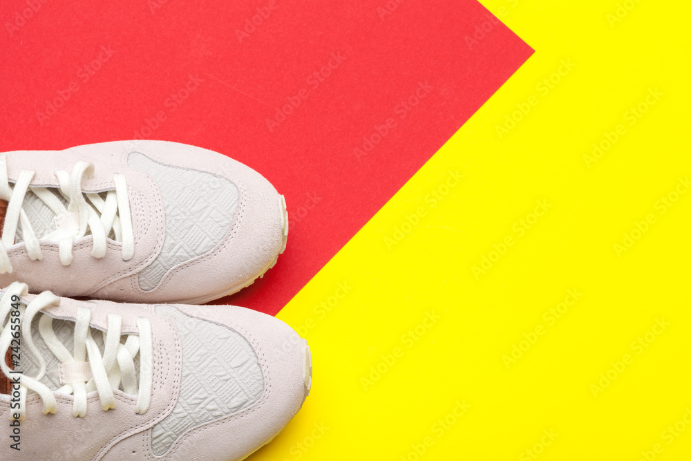 Pair of sport shoes on colorful background. New sneakers