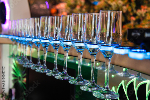 Glasses for champagne and wines in a special holder with lighting inside the limousine close-up