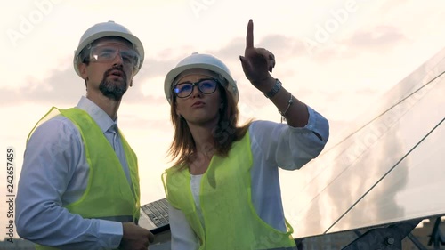 Professional enginners working on a roof, close up. photo