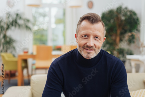 A mature, metro man looking at camera at home