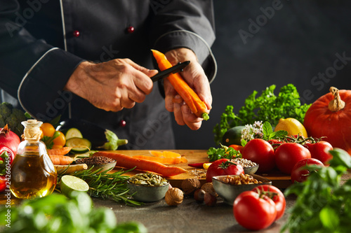 Chef slicing fresh carrots for a salad photo