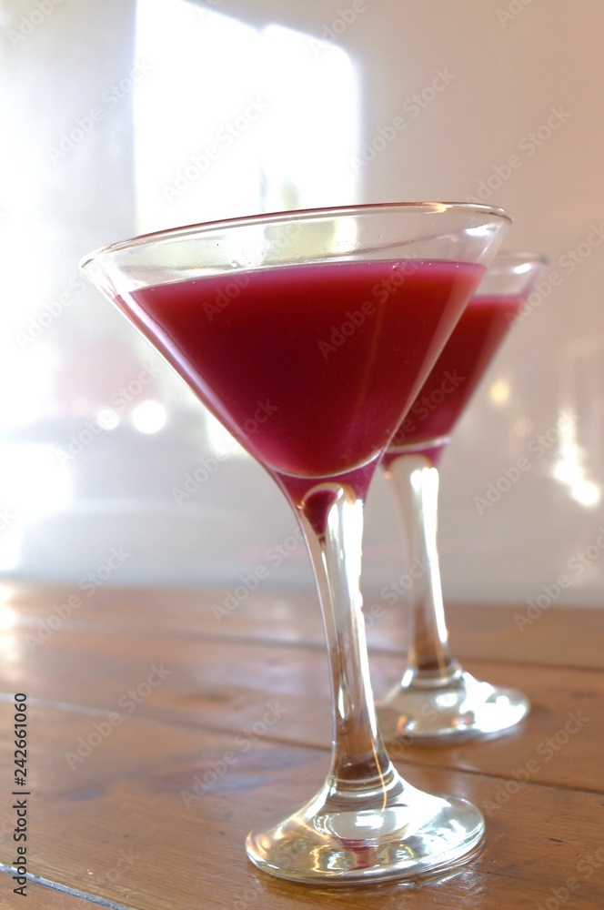 two flutes  of pink cocktail 