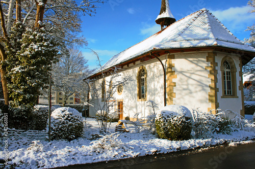 Snow covered old protestant church in Lyss, Switzerland. photo