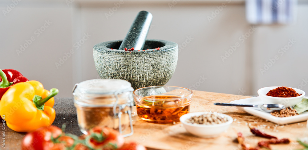 Stone pestle and mortar with oil and spices Stone pestle and mortar with oil and spices