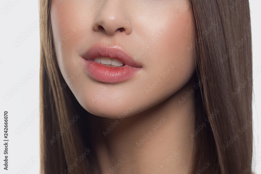 Beauty closeup of women full red lips with shiny skin and long hair. Facial  skin care