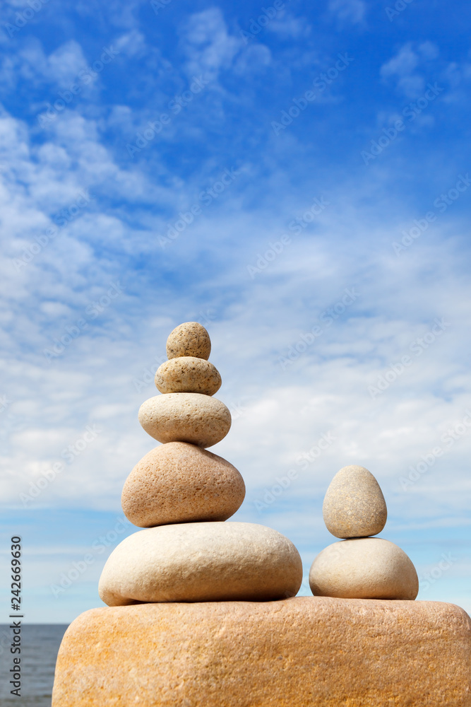 Rock zen pyramid of white stones on a background of blue sky and sea. Rock zen pyramid of white stones on a background of blue sky and sea.