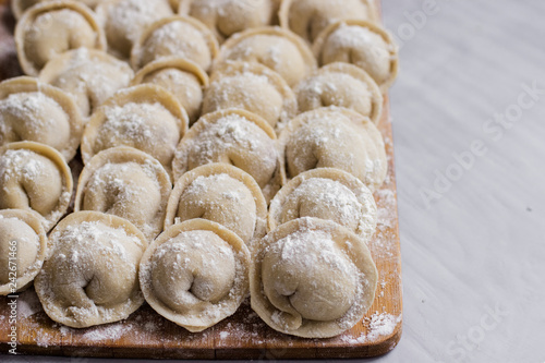 Raw frozen dumplings,pelmeni,ravioli on the board