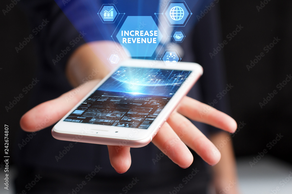 The concept of business, technology, the Internet and the network. A young entrepreneur working on a virtual screen of the future and sees the inscription: Increase revenue