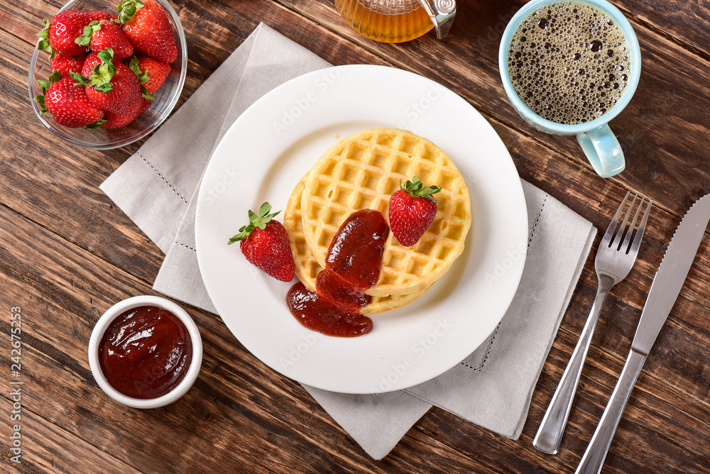 Waffles and jam on breakfast table Waffles and jam on breakfast table