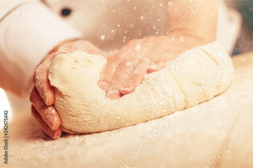 Billede på lærred Woman's hands knead the dough close up