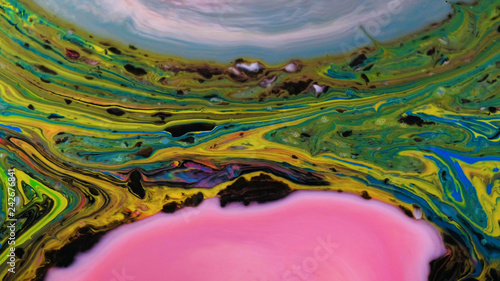 Multicolored psychedelic patterns of paint, colored liquid tapers