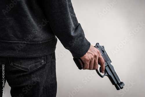 A man holding a gun in hand, the ship ready to shoot the man pointed a gun at us. A man holding a gun was robbed.