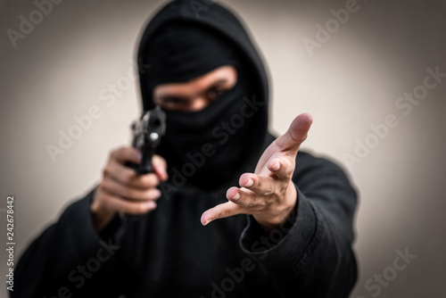 A man holding a gun in hand, the ship ready to shoot the man pointed a gun at us. A man holding a gun was robbed.