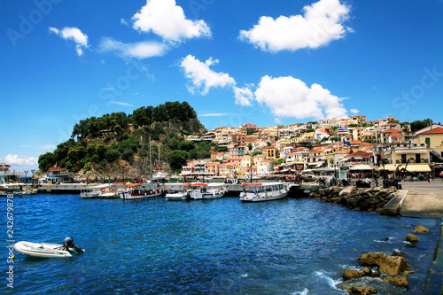 Wonderful view of colorful houses, boats and fortress in Parga, Greece