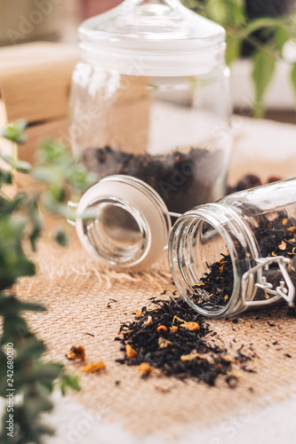 Black tea with natural additives in a glass jar.