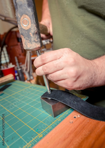 Flattening a Rivet into a Leather Strap photo