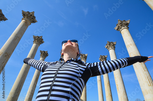 Female stands next to the Capitol Columns at the National Arboretum in Washington DC photo