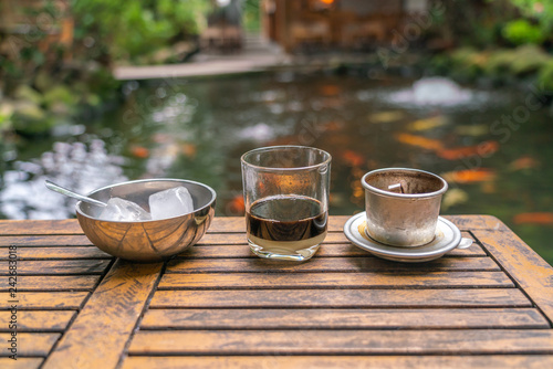 Traditional Vietnamese coffee with condensed milk with fish tank background