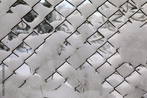 Rabitz. Metallic old mesh covered with snow.