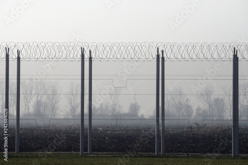 Prison fence with barbed wire