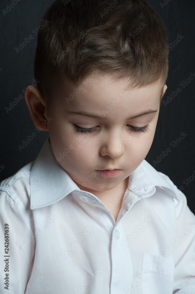 The little boy collects the designer from the details.