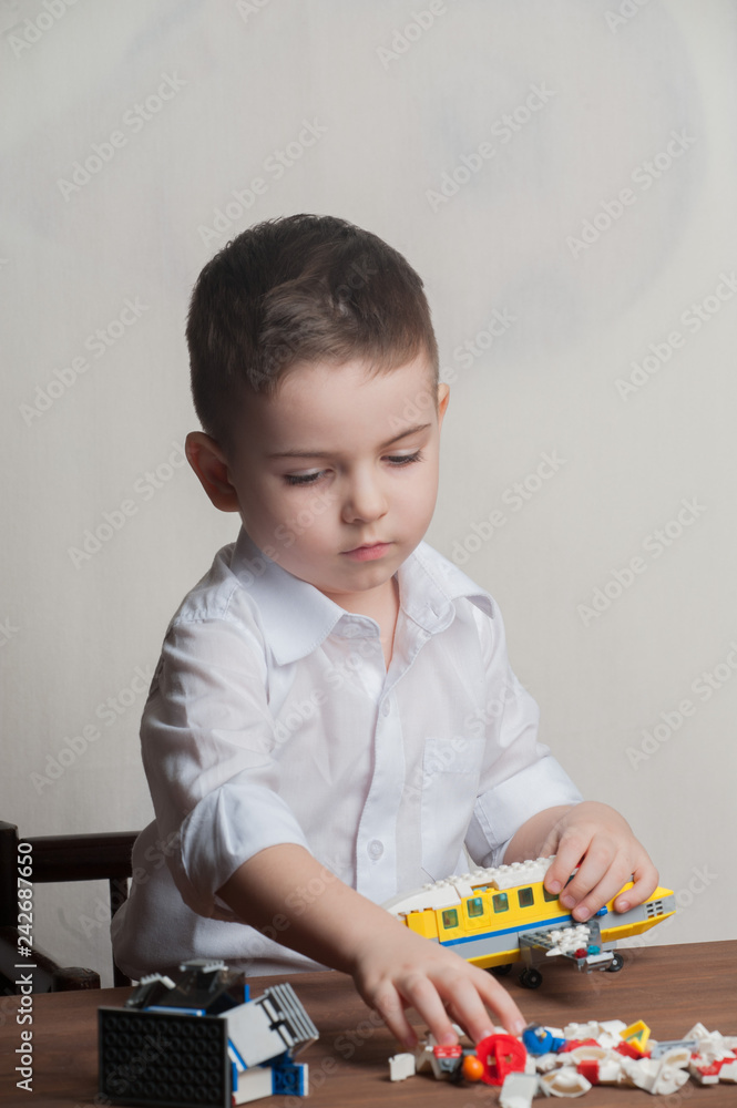 The little boy collects the designer from the details. The little boy collects the designer from the details.