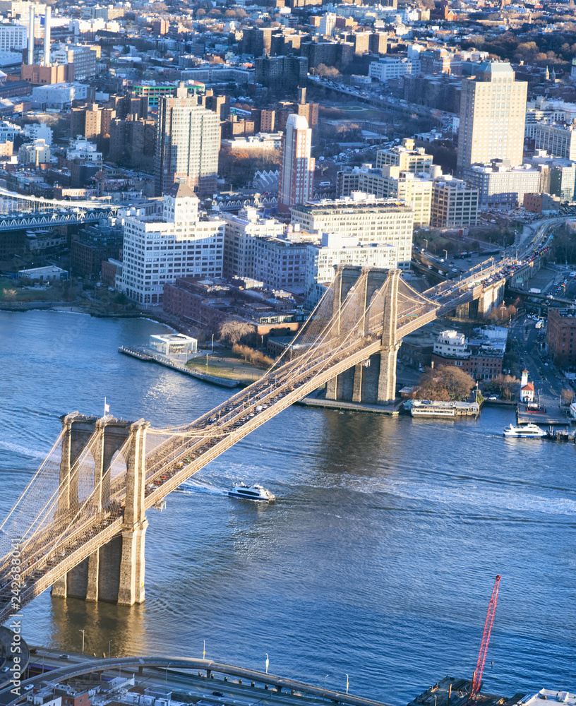 Brooklyn Bridge at sunset, amazing aerial view of New York City - USA