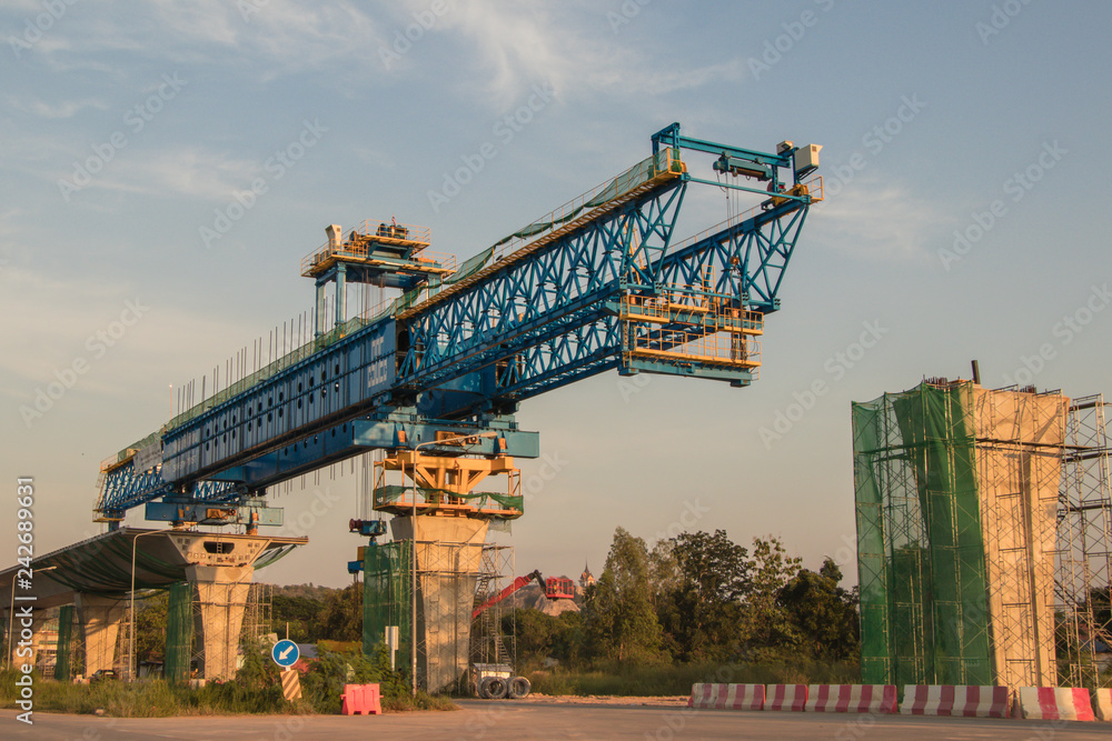 Construction crane and girder of bridge construction site.New expressway construction site and equipment.