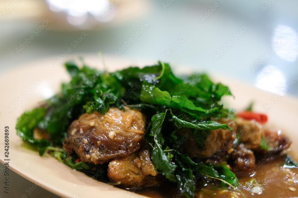 Stir-fried basil leave with fried preserved egg. Stir-fried basil leave with fried preserved egg.