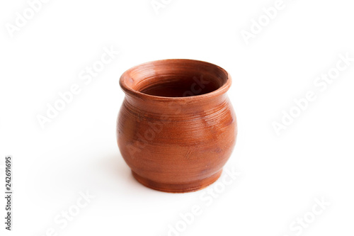 Clay pot, made by hand on a potter's wheel from red clay. Double burning. Transparent glaze applied by hand - visible potter's fingerprints and brush strokes. Handmade, single copy. isolated