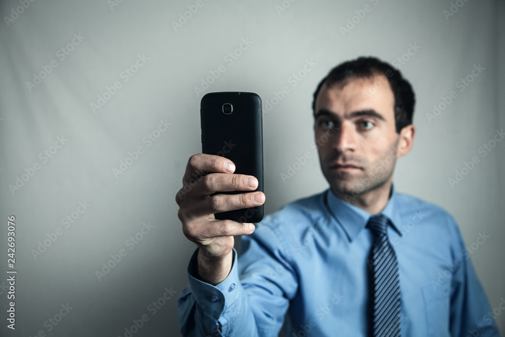 Caucasian businessman showing his smartphone. Caucasian businessman showing his smartphone.