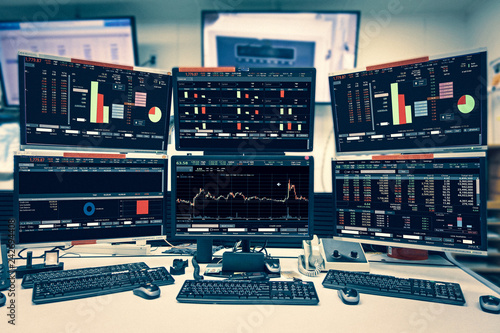 Display of Stock market quotes and chart in monitor computer room with business office equipments .business and money concept, panorama photo