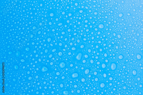 closeup drops water on blue background