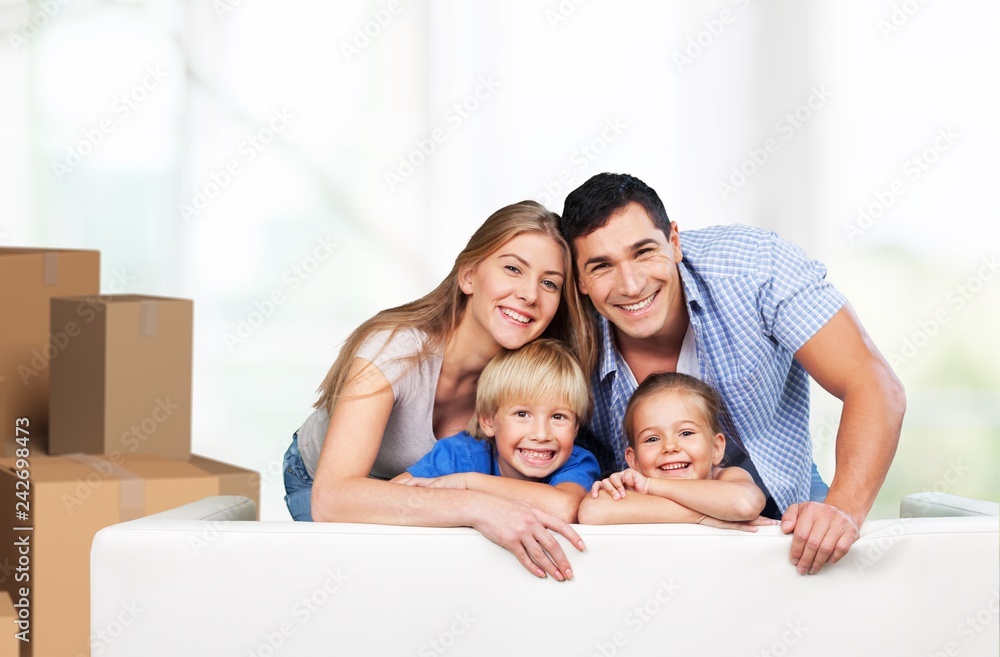 Beautiful smiling family sitting at sofa at home Beautiful smiling family sitting at sofa at home
