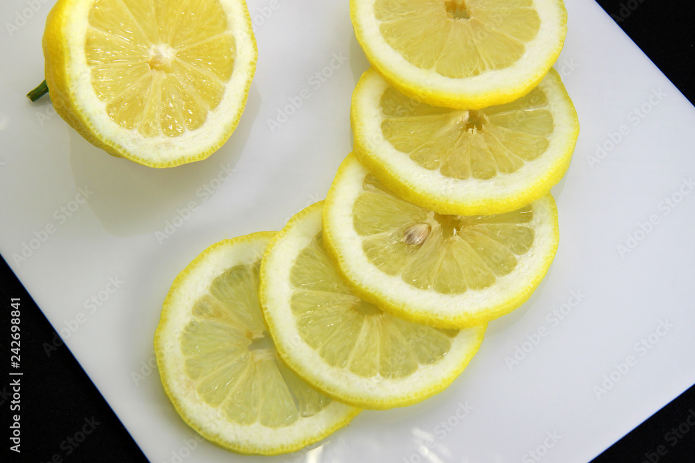 fresh cut slices of lemon on a white background fresh cut slices of lemon on a white background