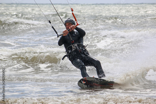kitesurfer riding his board