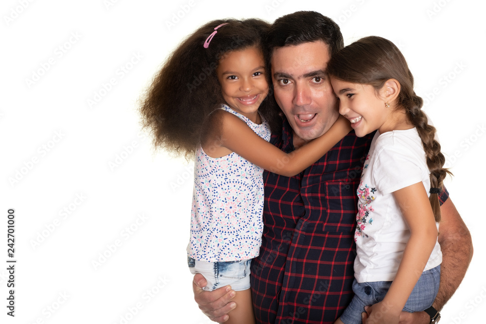 Multiracial family, Hispanic father with a funny expression hugging his mixed race daughters Multiracial family, Hispanic father with a funny expression hugging his mixed race daughters