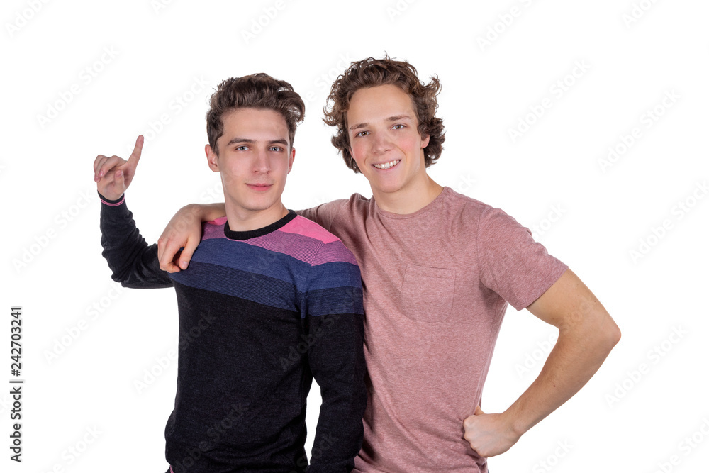 Portrait of a two happy young men pointing fingers isolated over white background Portrait of a two happy young men pointing fingers isolated over white background