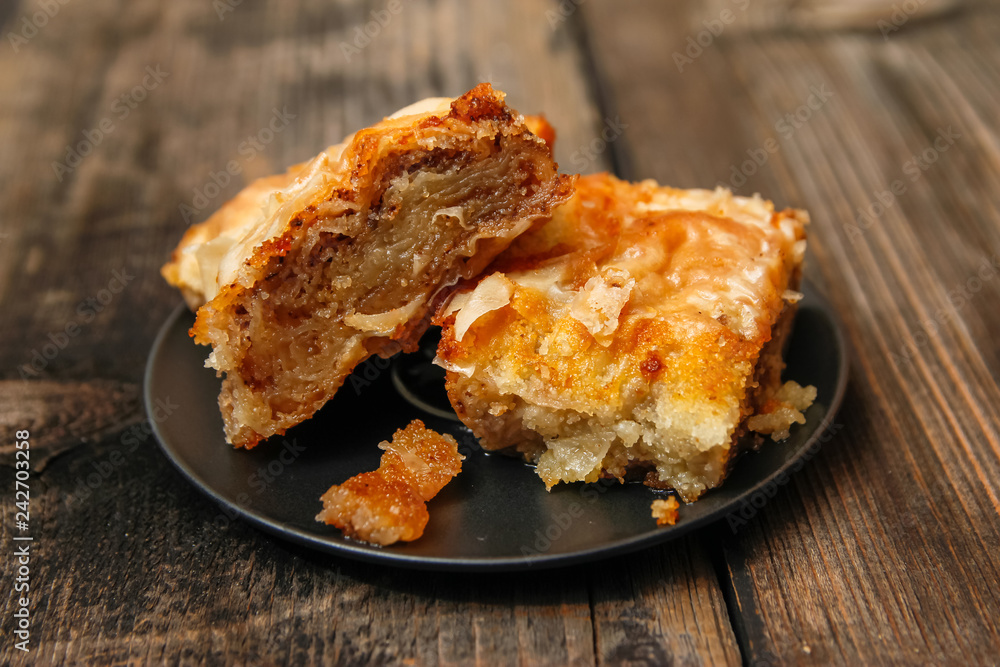 Baklava - homemade pie with walnuts on old wooden table Baklava - homemade pie with walnuts on old wooden table
