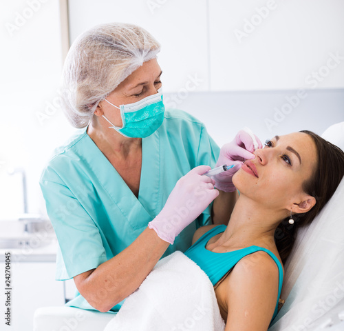 Woman during beauty facial injections